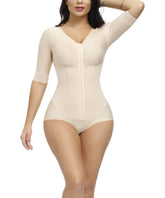 Woman wearing a beige shapewear bodysuit on a white background